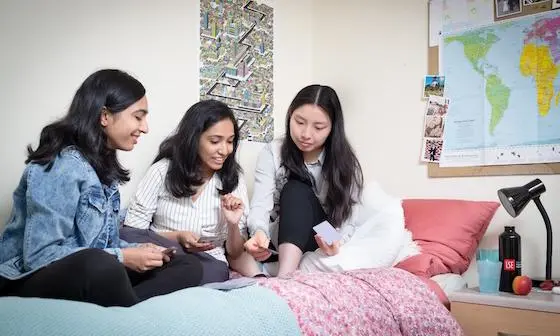 A group of students sat on a bed
