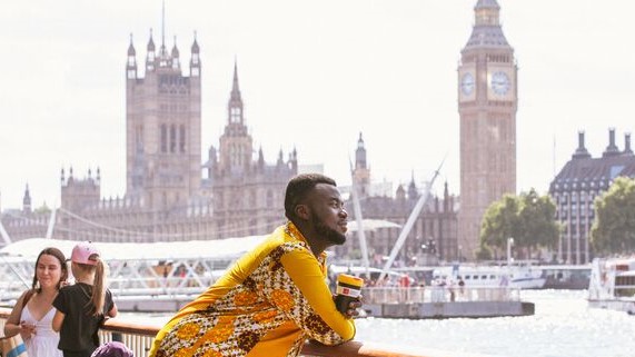 LSE student standing along River Thames in London with Big Ben in background